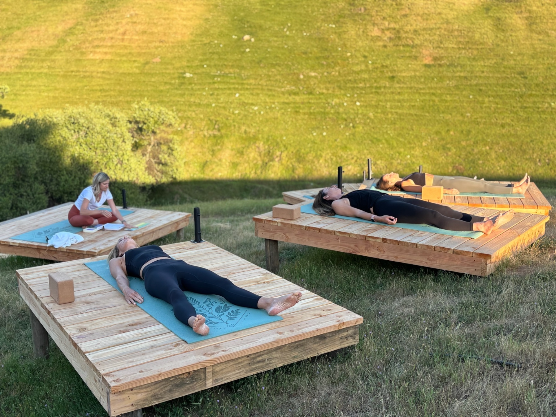 Guests resting on yoga platforms